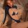 Woman modeling qingran cut-out thong bodysuit, a sexy open-crotch one-piece lingerie set with sheer bust detail and white tri...