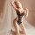 Woman kneeling in black lace bodysuit with cut-outs, sheer fabric, and sensual design.