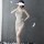 A woman poses in a beige qingran sexy lace chemise set, featuring a backless design with a slit, perfect for sleepwear or lou...