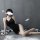 A woman poses in a black qingran sexy lace chemise set, featuring a backless design with a slit, perfect for sleepwear or lou...