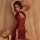 A woman poses elegantly in a red lace bodysuit featuring cut-out details and traditional frog closures, reminiscent of a qing...