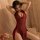A woman poses elegantly in a red lace qingran sexy lingerie set, featuring a cheongsam style bodysuit with ties, cut-out deta...