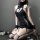 Woman in black high-neck backless lace knit lingerie set with mesh details and thigh-high stockings.