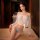Woman wearing qingran summer sexy cover-up bikini set with butterfly hip tie and lingerie-style top, sheer white overlay.