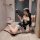 A woman poses elegantly in a vintage-inspired dress featuring a seductive peony print, bodycon fit, and tassels, holding a de...