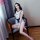Woman in qingruohan backless maid costume with lace trim, sitting on chair—seductive lingerie set for women.