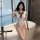 A woman poses elegantly in a white qingruohan japanese-style sexy lingerie bodysuit featuring a cute tie-up design, highlight...