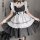 A woman wearing a black and white maid costume, featuring lace details and sheer mesh apron, perfect for cosplay or themed ev...