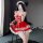 Woman wearing red qingruohan maid costume lingerie set with lace trim, bow details, and fishnet stockings in bedroom setting.