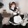 Woman in qingruohan maid costume with white apron, black bow, and frilly details, posing with tray and plush toys.
