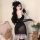 Woman wearing qingruohan sheer black lingerie set with lace trim, feather headpiece, and gloves, posing beside teddy bears an...