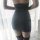 Sheer black bodycon dress with hook-neck design, featuring a form-fitting silhouette and thigh-high stockings for a seductive...