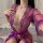 Woman wearing purple sheer lace lingerie set with deep v-neck and ribbon tie, designed for small bust enhancement.