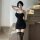 Woman wearing black qingruohan sensual no-remove strap sleepwear set with thigh-high stockings, posing by glass staircase.