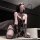 Model wearing qingshe embroidered lingerie set with lace bra, thong, and long gloves.