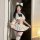 A stylish model showcases the qingshe jk flirty lingerie set, featuring a pleated skirt with elegant details and playful cat ...