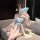 Woman in qingshe lingerie set with sheer robe and fan, elegant chinese-inspired design.
