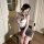 Woman in elegant qingshe ol secretary lingerie set with lace bra, panty, and eye mask, sitting on chair.