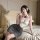Woman wearing qingshe ol secretary lingerie set with lace bra, gray skirt, and eye mask on bed.