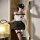 Woman wearing qingshe police officer cosplay lingerie set with cap, harness top, mini skirt, and thigh-high stockings.