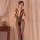 Woman modeling black sheer mesh bodystocking with open-crotch design and lace detailing, styled as seductive one-piece linger...