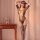 Woman wearing qingyege plus size sheer mesh bodysuit with open crotch and attached stockings, posing indoors.