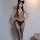 Woman wearing qingyege sheer mesh bodysuit with open-crotch design and matching lace-trimmed stockings, paired with cat ears.