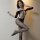 Woman wearing qingyege sheer mesh bodysuit with open-crotch design and matching stockings, posing elegantly against a neutral...