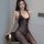 A woman poses elegantly wearing a qingyege sensual sheer mesh bodysuit with an open-crotch design, accentuated by lace detail...