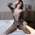 Woman wearing qingyege sheer mesh lace bodysuit with open-crotch design, posing on bed in plus size lingerie.