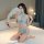 Woman kneeling on bed in qingyege sheer blue mesh lingerie set with lace trim and tear-away design, holding white feather fan...