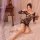Woman wearing qingyege bold striped mesh bodycon lingerie with cut-out details, posing on bed in cozy bedroom setting.