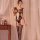 Woman modeling qingyege sheer mesh lingerie set with open-crotch top and stockings in soft-lit bedroom.
