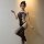 Woman modeling qingyege sheer mesh bodysuit with thigh-high stockings, featuring cutout details and seductive design.