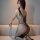 Woman wearing qingyege sexy mesh bodysuit with open-crotch design, showcasing alluring bodycon fit and seductive net lace det...