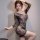 Woman modeling qingyege black mesh lingerie set with sheer floral-patterned stockings, posing seductively in bedroom-style ou...