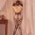 Woman wearing qingyege backless lace bodysuit with open-crotch mesh design and sheer stockings, posing by curtains.