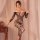 Woman modeling qingyege sheer lace bodysuit with mesh panels, backless design, and attached stockings in soft lighting.