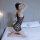 Woman kneeling on bed wearing qingyege sheer black bodystocking with open-knit design, showcasing transparent temptation ling...