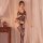 Woman wearing qingyege black mesh bodystocking with open-crotch and lace thigh-highs, posed beside wooden nightstand.