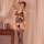 Woman modeling qingyege black mesh bodystocking with open-crotch and lace thigh-highs in soft-lit bedroom setting.