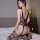 Woman wearing qingyege sheer mesh bodysuit with open-crotch design and thigh-high stockings, kneeling on bed.