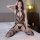 Woman wearing qingyege sheer mesh bodysuit with open-crotch design and thigh-high stockings, posing on bed in lingerie set.