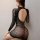 Woman wearing black sheer floral mesh bodysuit with open back and long sleeves, bodycon fit.