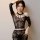 Woman wearing black lace lingerie set with sheer sleeves and matching stockings, posing seductively for intimate role-play.