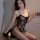 Woman wearing qingyeguo black lace bodysuit with sheer mesh and open-crotch stockings, elegant erotic lingerie set.