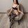 Woman wearing qingyeguo black lace bodysuit with sheer mesh, open-crotch design, and patterned thigh-high stockings.