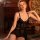 Woman wearing qinmu sexy lace lingerie set – sheer mesh cami and briefs, elegant black sleepwear in vintage room setting.