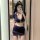 Woman in navy blue airline-style lingerie set with mini skirt, posing in mirror selfie.