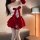 Woman wearing red and white qqny christmas sexy bunny girl dress costume set with bow, fluffy trim, and thigh-high stockings.